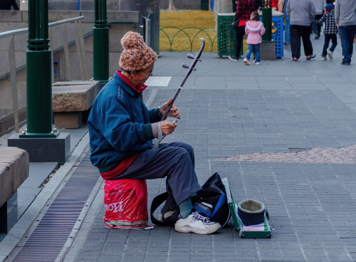 Street Photography Man playing an instrument